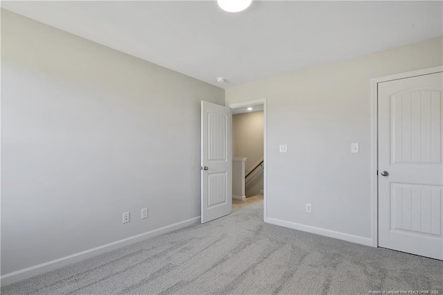 unfurnished bedroom with carpet and baseboards
