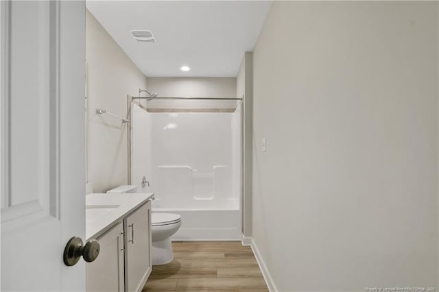 full bathroom with toilet, wood finished floors, vanity, visible vents, and shower / bathing tub combination