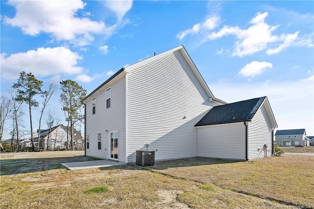 view of home's exterior featuring a yard, central AC unit, and a patio area