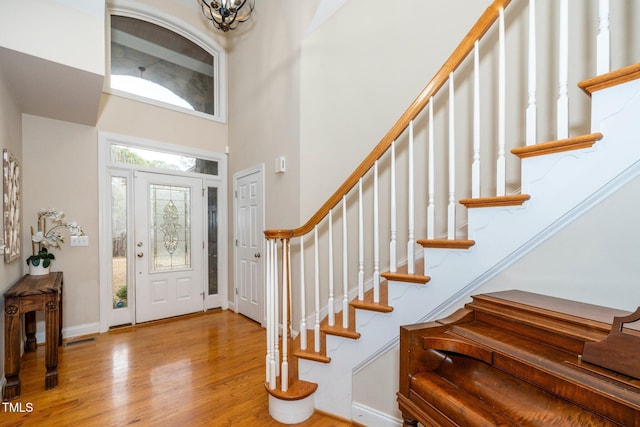 foyer featuring light hardwood / wood-style floors and a high ceiling