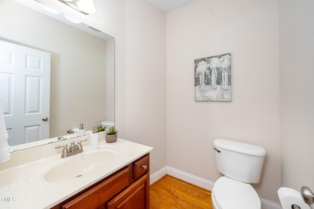 bathroom with vanity, wood-type flooring, and toilet