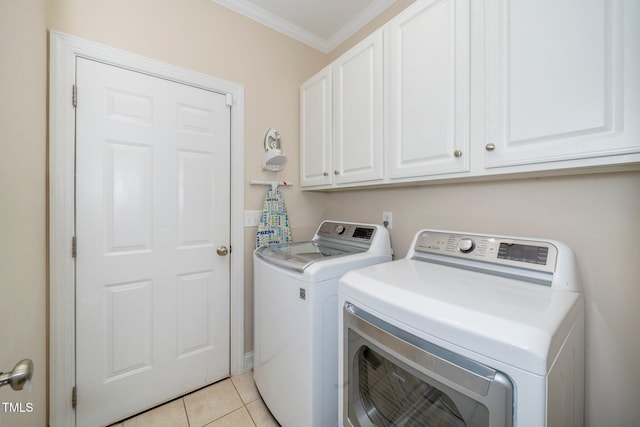 laundry room featuring cabinets, crown molding, independent washer and dryer, and light tile patterned flooring