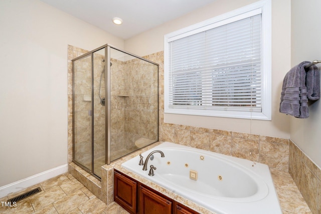 bathroom featuring independent shower and bath