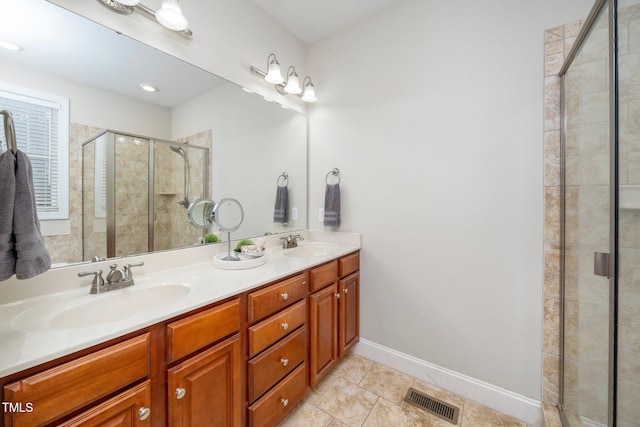 bathroom with vanity, an enclosed shower, and tile patterned floors