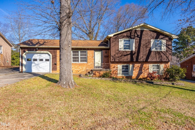 tri-level home with a garage and a front yard