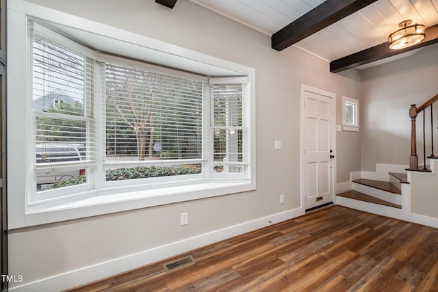 foyer with dark hardwood / wood-style floors, wood ceiling, and beam ceiling