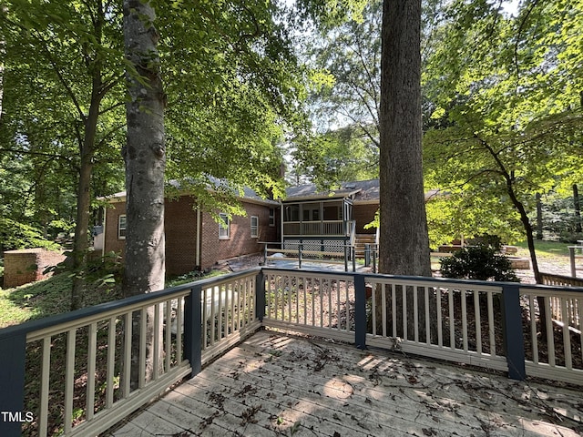 wooden terrace featuring a sunroom