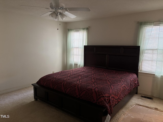 carpeted bedroom with a ceiling fan