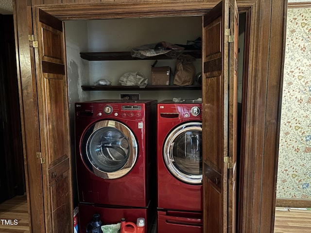 laundry area with separate washer and dryer and wood finished floors