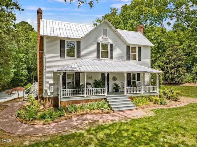 967 Bynum Rd, Pittsboro, NC 27312 - view of front of house featuring a chimney, a porch, and metal roof