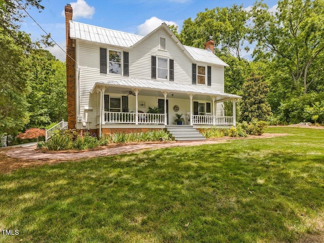 967 Bynum Rd, Pittsboro, NC 27312 - view of front of house featuring a chimney, a porch, a standing seam roof, and a front lawn