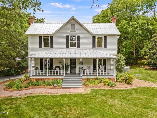 967 Bynum Rd, Pittsboro, NC 27312 - view of front facade featuring a porch, a chimney, and metal roof