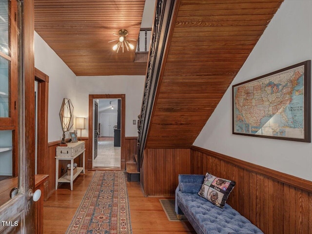 967 Bynum Rd, Pittsboro, NC 27312 - hallway with a wainscoted wall, wood ceiling, wooden walls, light wood-type flooring, and lofted ceiling