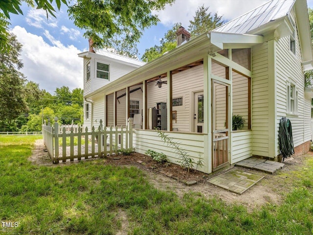 967 Bynum Rd, Pittsboro, NC 27312 - view of side of property featuring a chimney, a sunroom, metal roof, and a standing seam roof