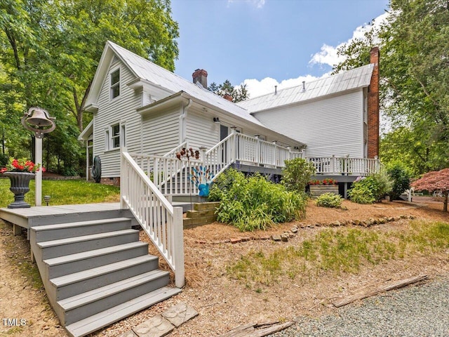 967 Bynum Rd, Pittsboro, NC 27312 - view of side of property with a deck, a chimney, metal roof, and crawl space