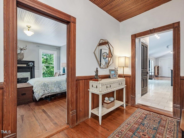 967 Bynum Rd, Pittsboro, NC 27312 - hallway with wainscoting, wood finished floors, vaulted ceiling, wood ceiling, and wood walls