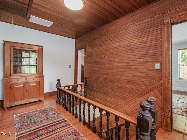 967 Bynum Rd, Pittsboro, NC 27312 - corridor featuring an upstairs landing, wood walls, light wood-type flooring, baseboards, and wood ceiling