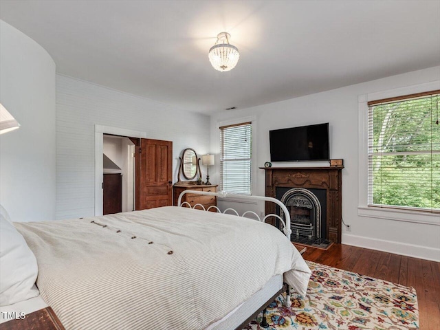 967 Bynum Rd, Pittsboro, NC 27312 - bedroom featuring wood finished floors, multiple windows, a fireplace, and baseboards