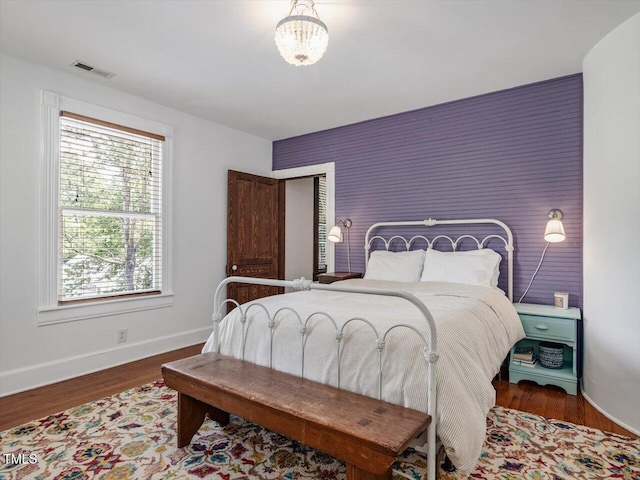 967 Bynum Rd, Pittsboro, NC 27312 - bedroom featuring an accent wall, baseboards, and wood finished floors
