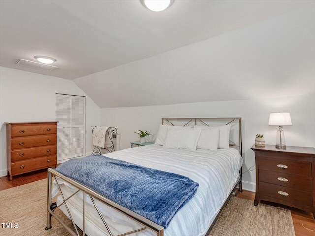 967 Bynum Rd, Pittsboro, NC 27312 - bedroom with wood finished floors, lofted ceiling, a closet, and baseboards