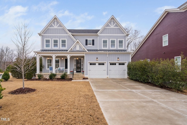 view of front of home with a garage, a front lawn, and a porch