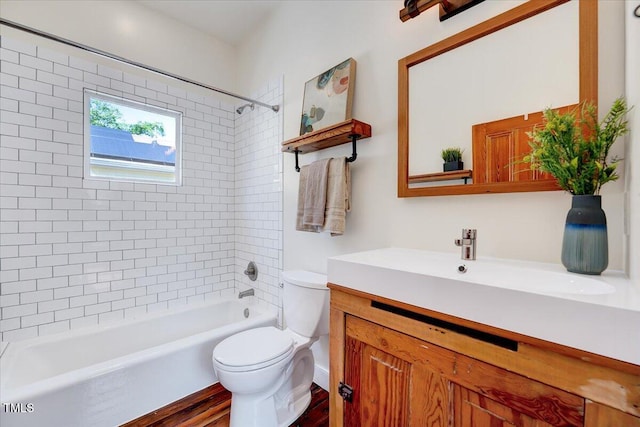 full bathroom with tiled shower / bath combo, vanity, and toilet