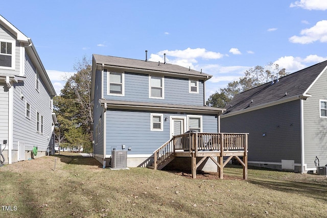 rear view of property featuring a wooden deck, a yard, and central air condition unit