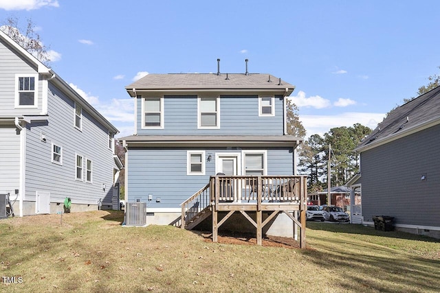 back of house featuring a wooden deck, central AC unit, and a lawn