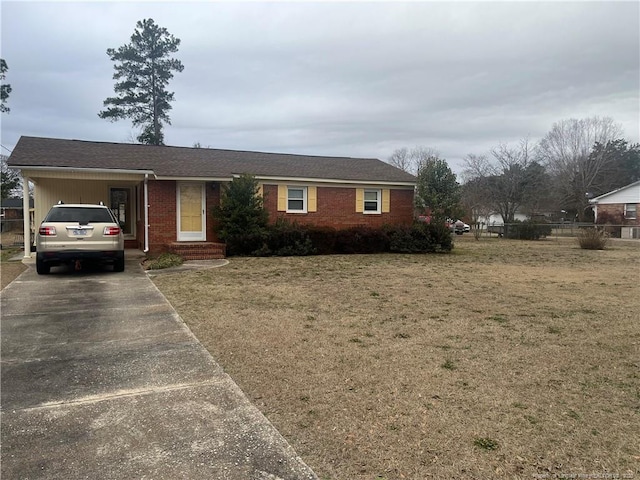 ranch-style home with a front yard and a carport