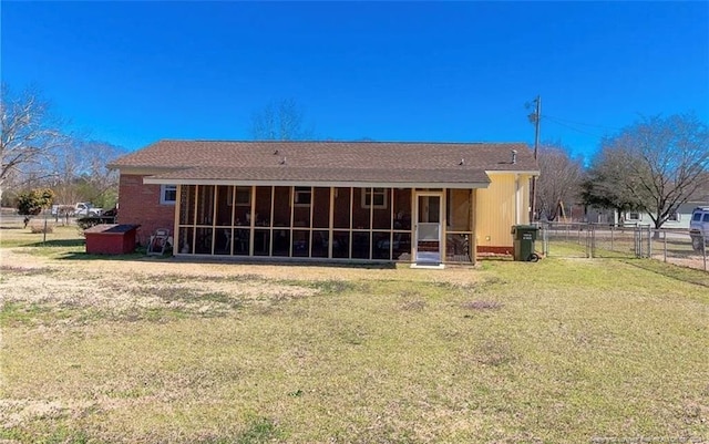 back of house featuring a yard and a sunroom