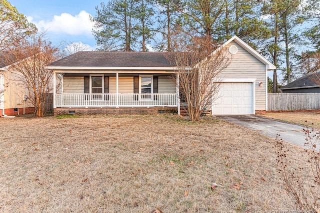 ranch-style home with a garage, a front yard, and covered porch