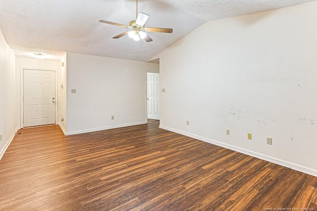 spare room with dark hardwood / wood-style flooring, a textured ceiling, lofted ceiling, and ceiling fan