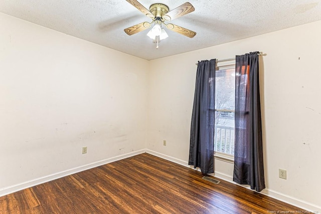 unfurnished room featuring ceiling fan, dark hardwood / wood-style flooring, and a textured ceiling