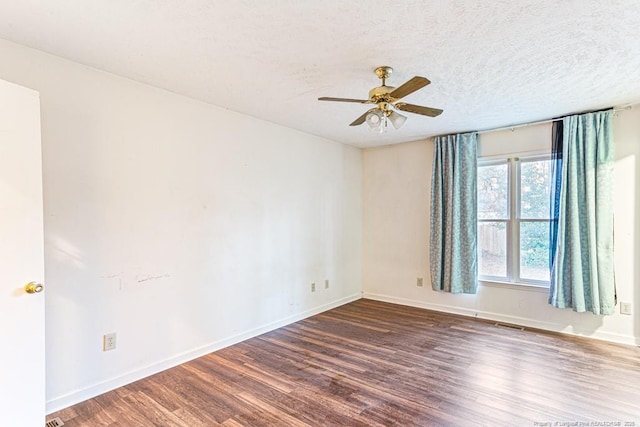 spare room with ceiling fan, dark hardwood / wood-style floors, and a textured ceiling