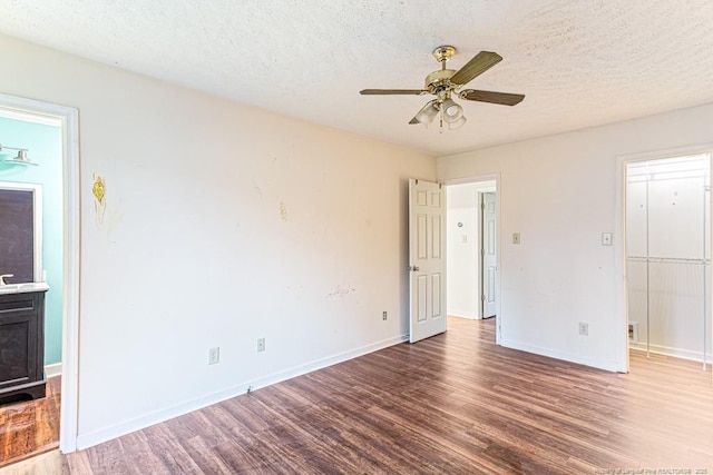 interior space with ceiling fan, hardwood / wood-style flooring, a textured ceiling, and ensuite bathroom