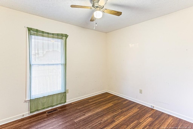 unfurnished room with visible vents, baseboards, ceiling fan, wood finished floors, and a textured ceiling