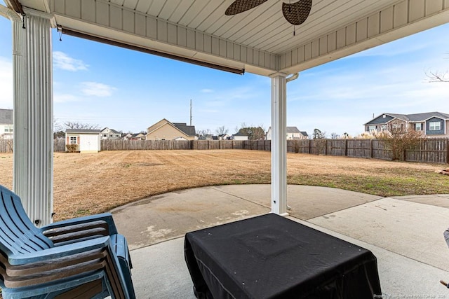 view of patio / terrace with ceiling fan and a storage unit