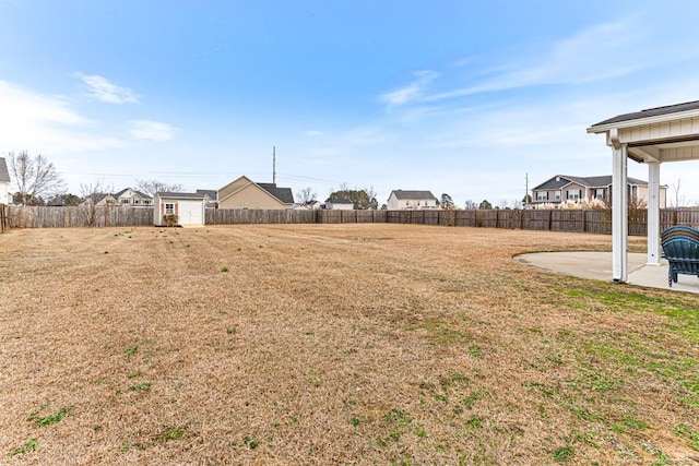 view of yard featuring a patio and a storage shed