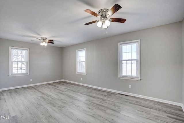 spare room featuring light hardwood / wood-style flooring and ceiling fan