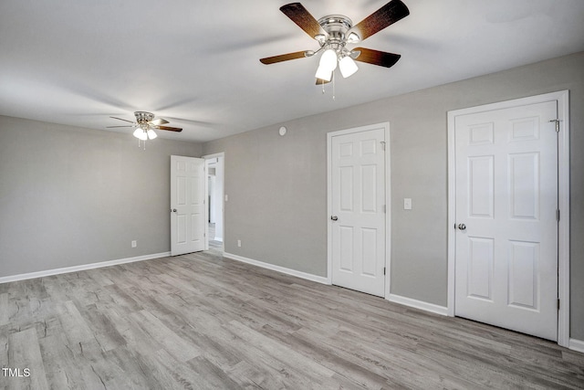 unfurnished bedroom with ceiling fan and light hardwood / wood-style floors