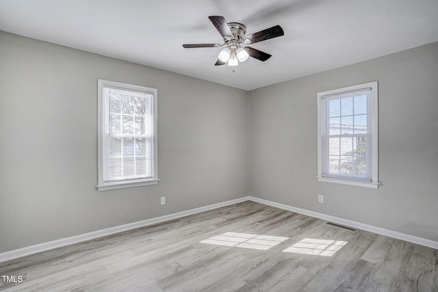 unfurnished room with ceiling fan and light wood-type flooring