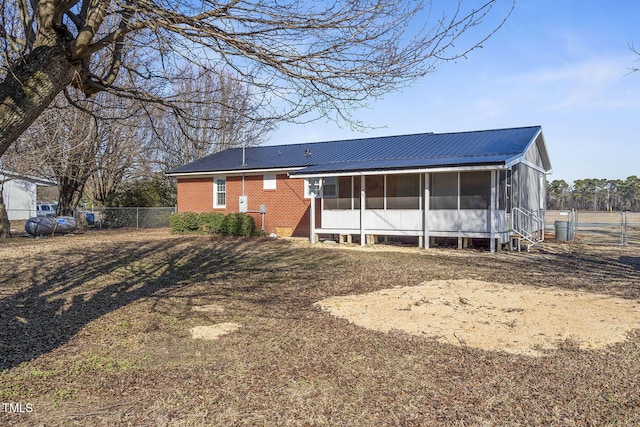 back of property with a sunroom