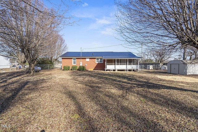 view of front of property with a storage shed and a sunroom