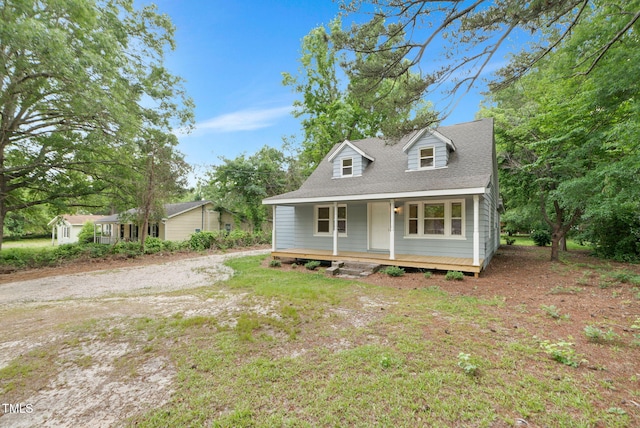 view of front of house featuring covered porch and a shingled roof