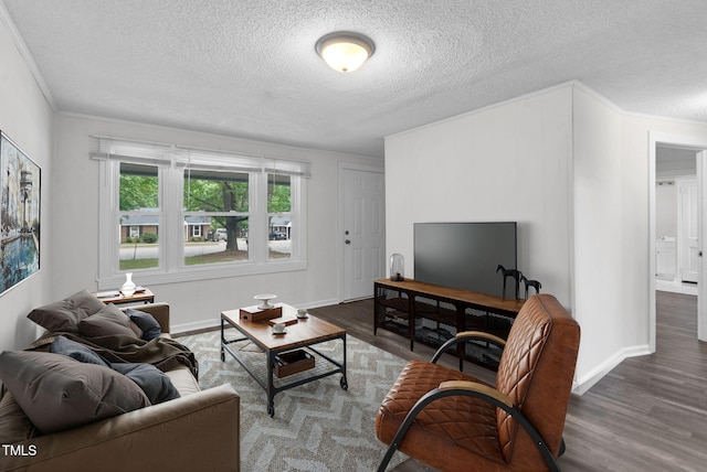 living area featuring a textured ceiling, wood finished floors, crown molding, and baseboards