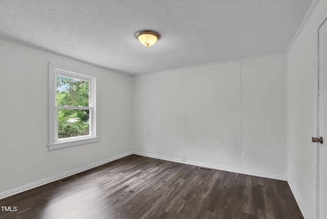 empty room with dark wood-type flooring, a textured ceiling, and baseboards