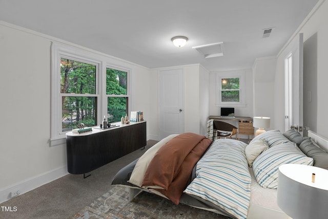 carpeted bedroom with attic access, multiple windows, a desk, and baseboards