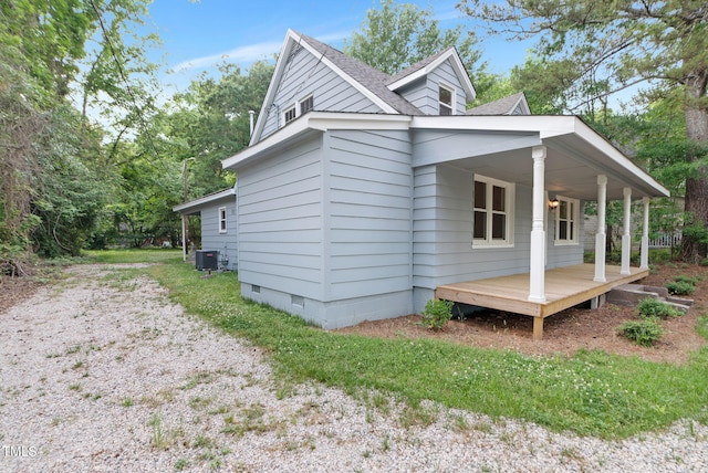 view of side of property featuring central AC, crawl space, and roof with shingles