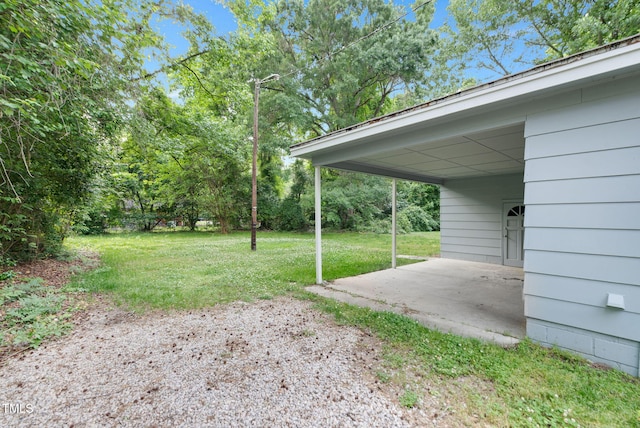 view of grassy yard with a patio