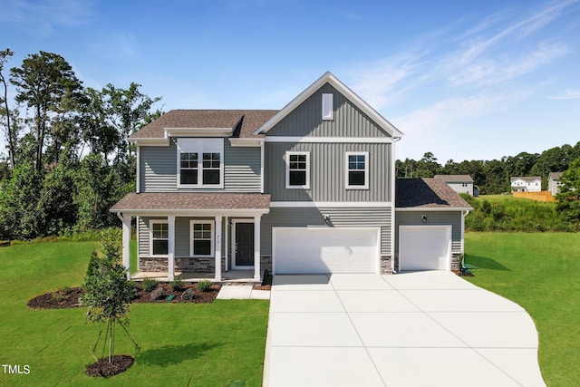 view of front of house featuring driveway, a front lawn, stone siding, board and batten siding, and covered porch